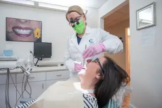 Dentist treating patient in exam room